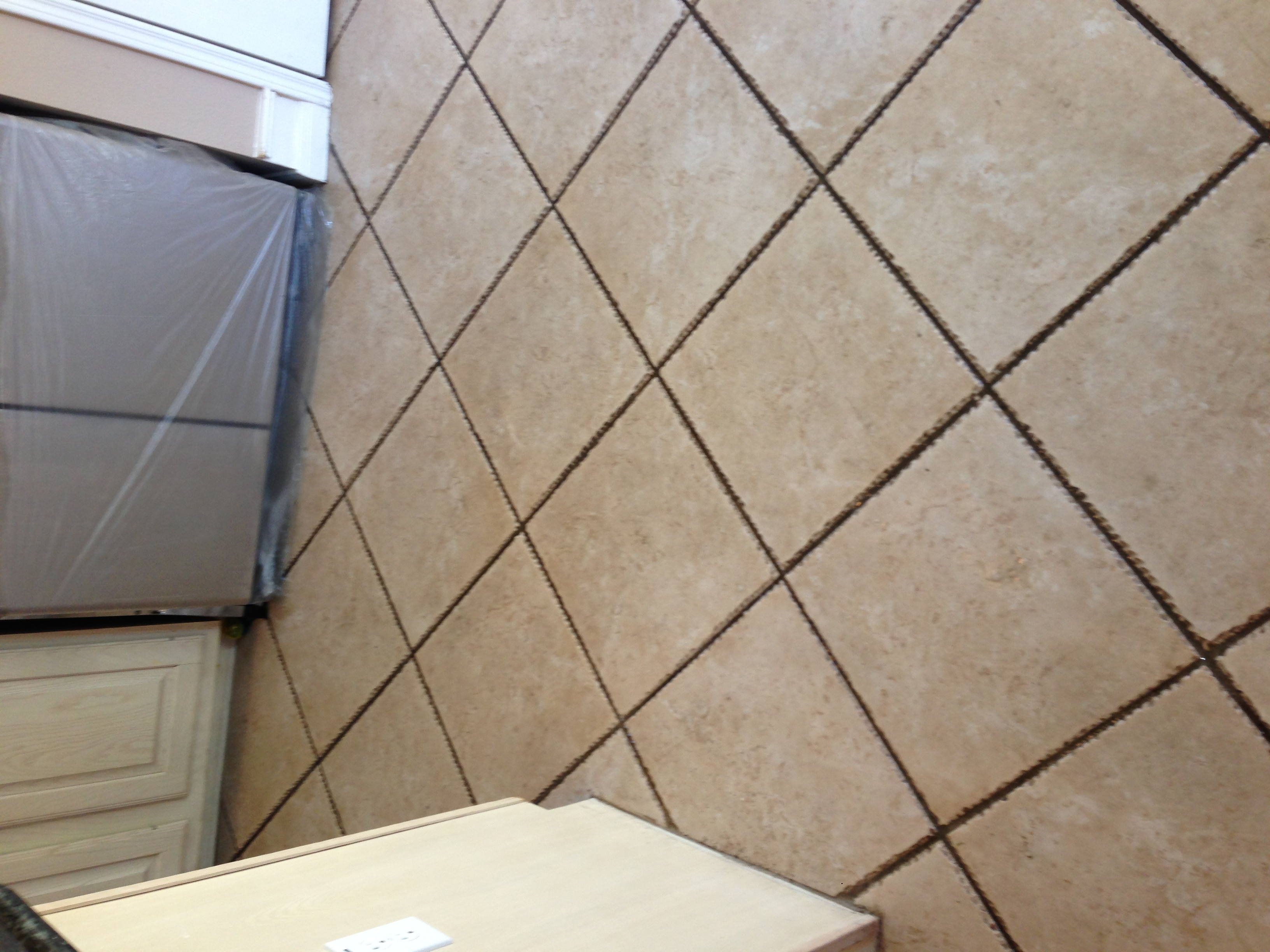 Kitchen tile floor with grout restored after professional cleaning